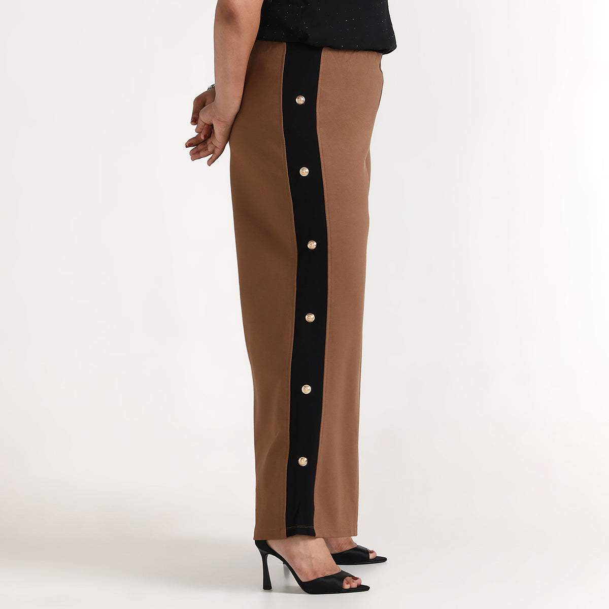 Brown pants with a black side panel featuring gold buttons on a white background