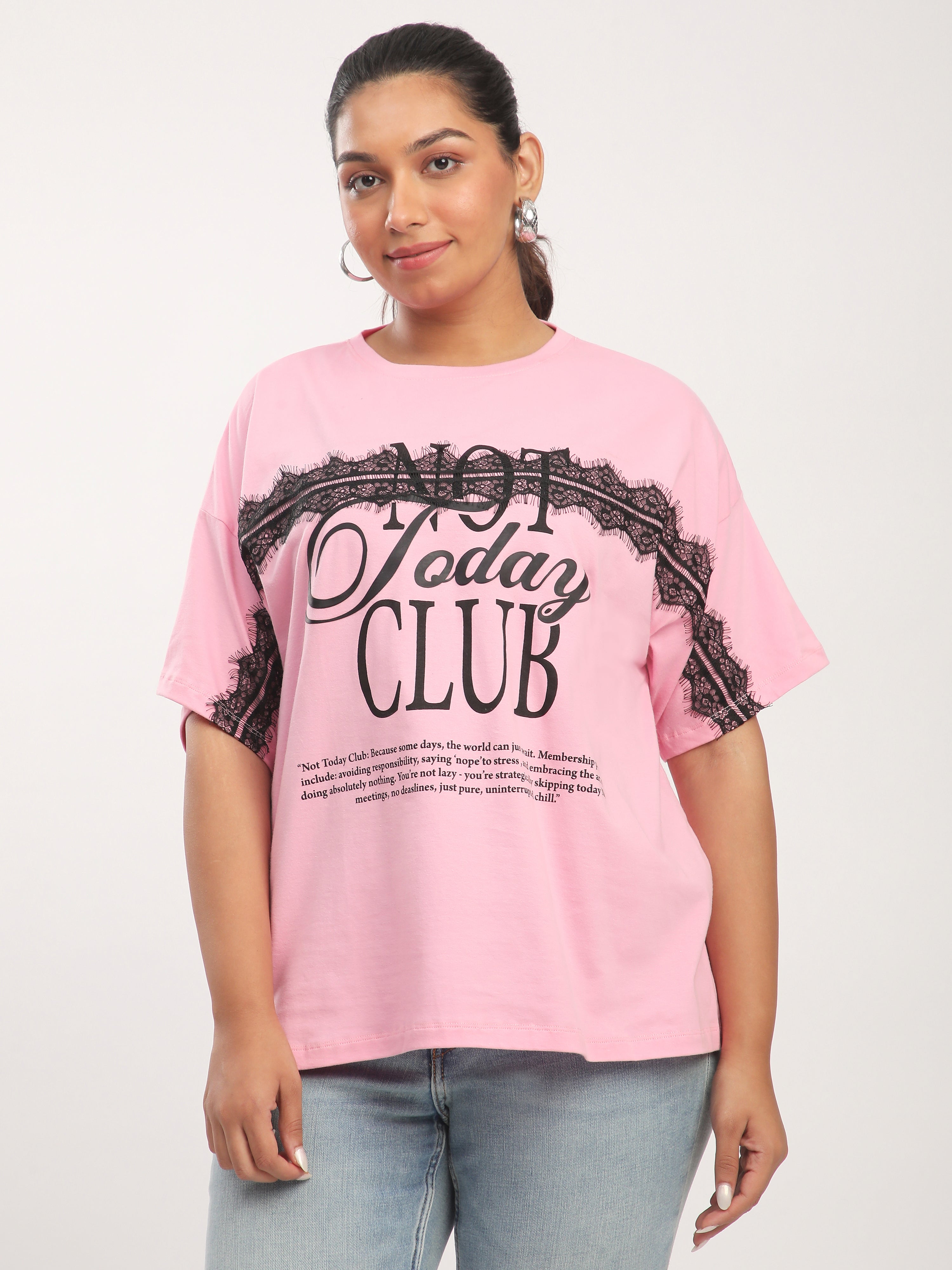 Person wearing a pink t-shirt with text and graphics on a white background