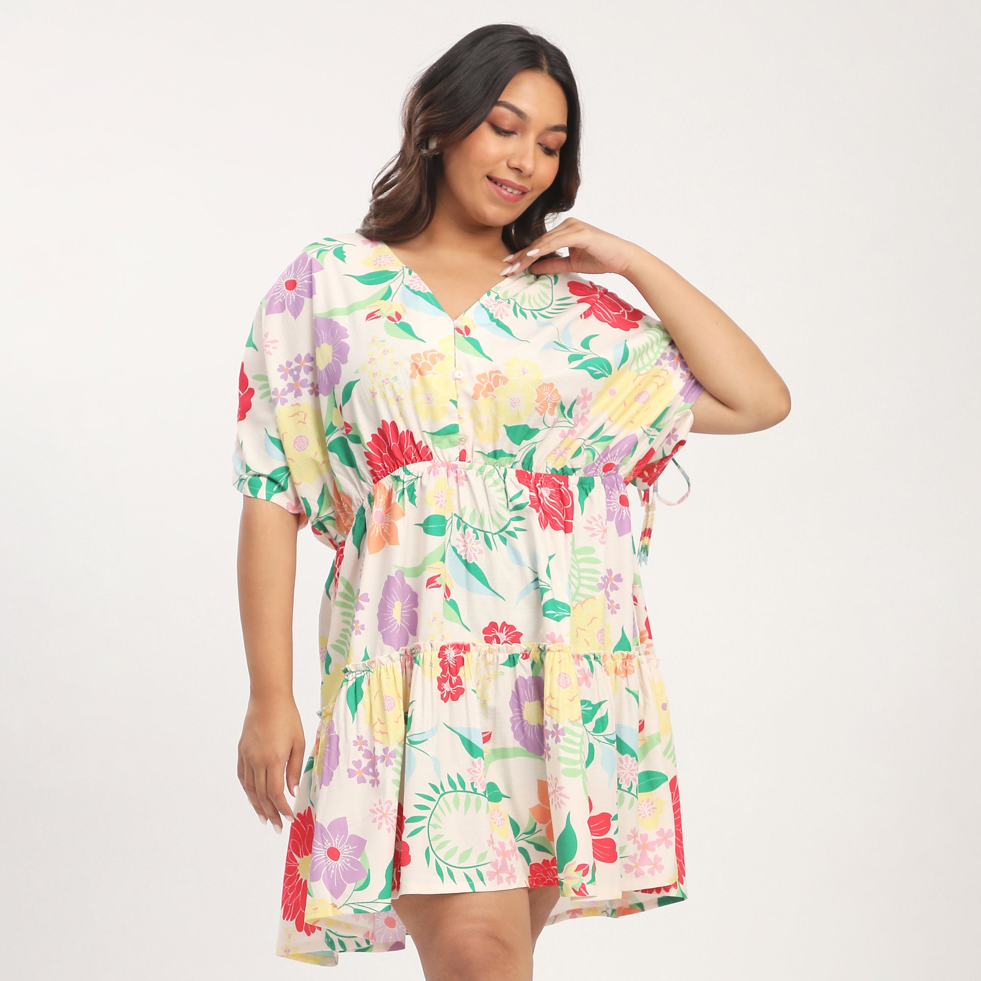 Woman wearing a floral dress on a plain background