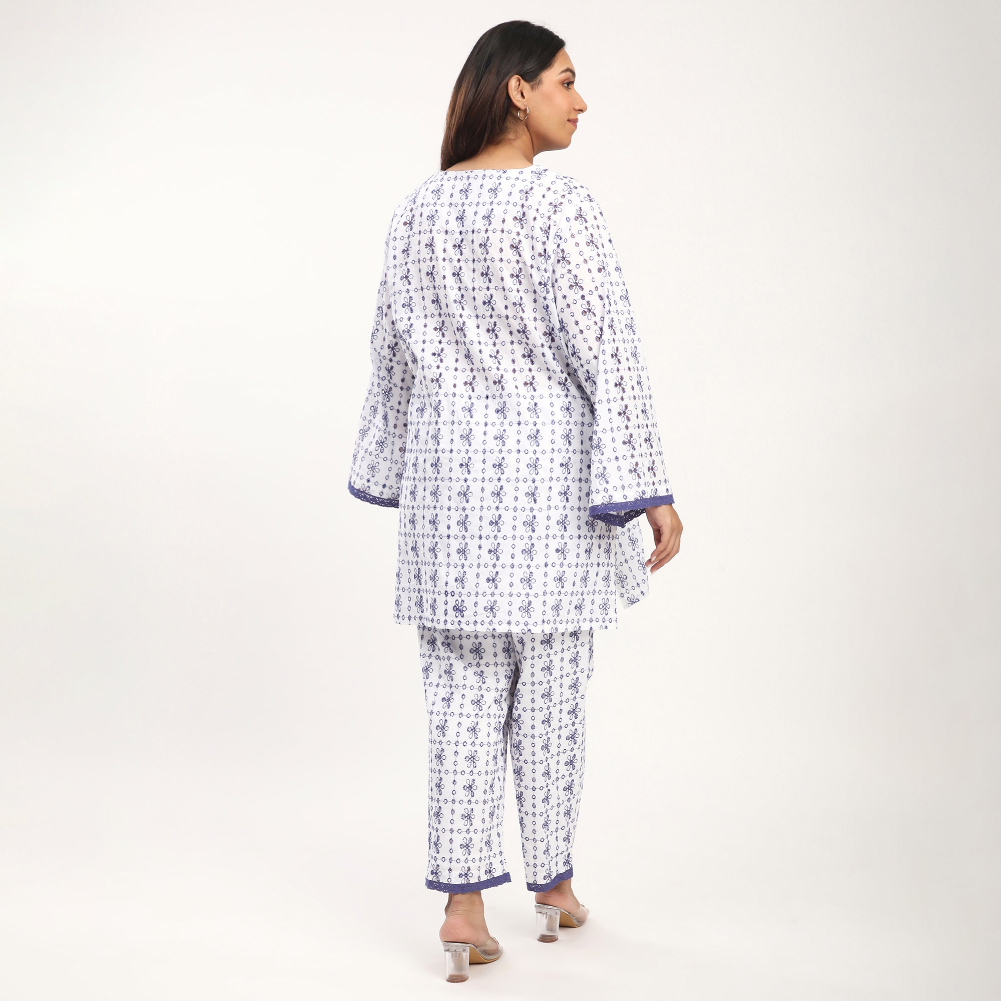 Person wearing a patterned co ord set on a plain background