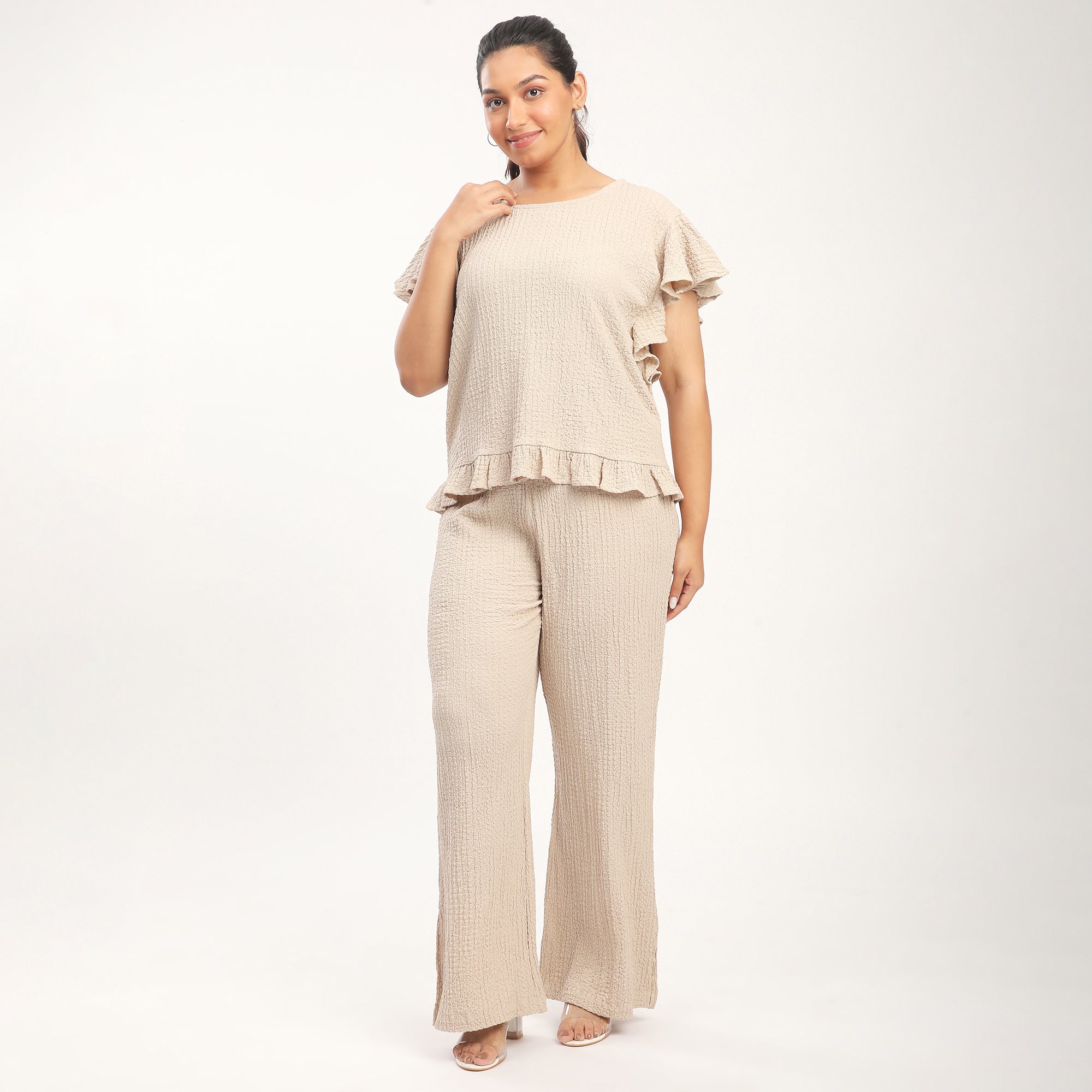 Woman wearing a beige outfit on a white background