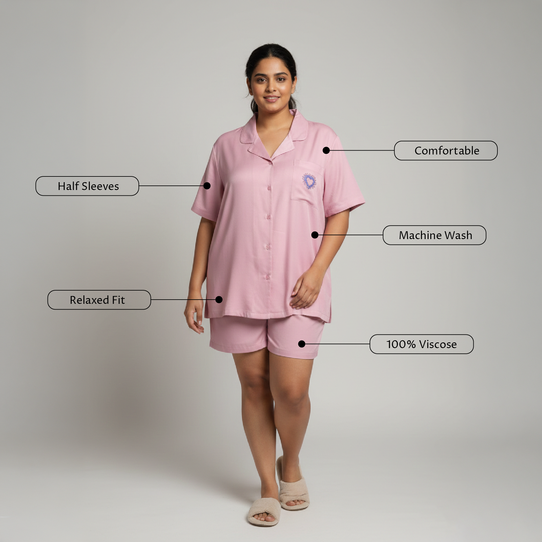 Woman wearing a pink pajama set with feature labels on a gray background