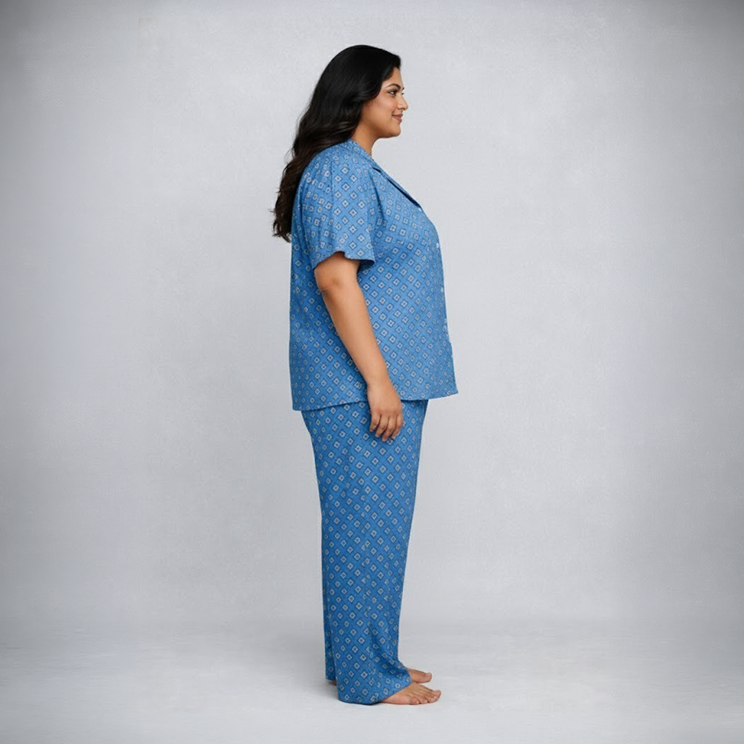 Woman wearing a blue pajama set against a plain background