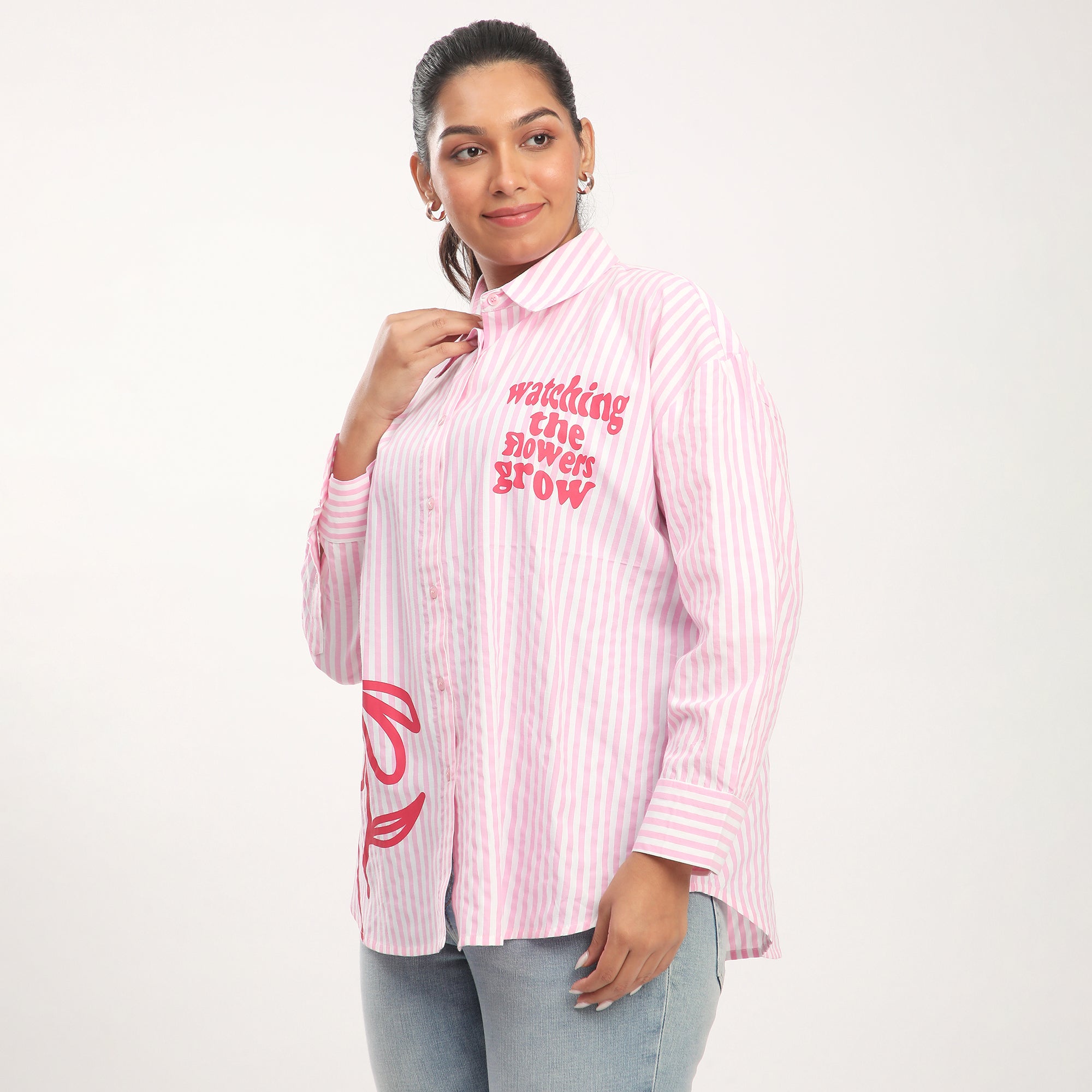 Woman wearing a pink and white striped shirt with text on a white background