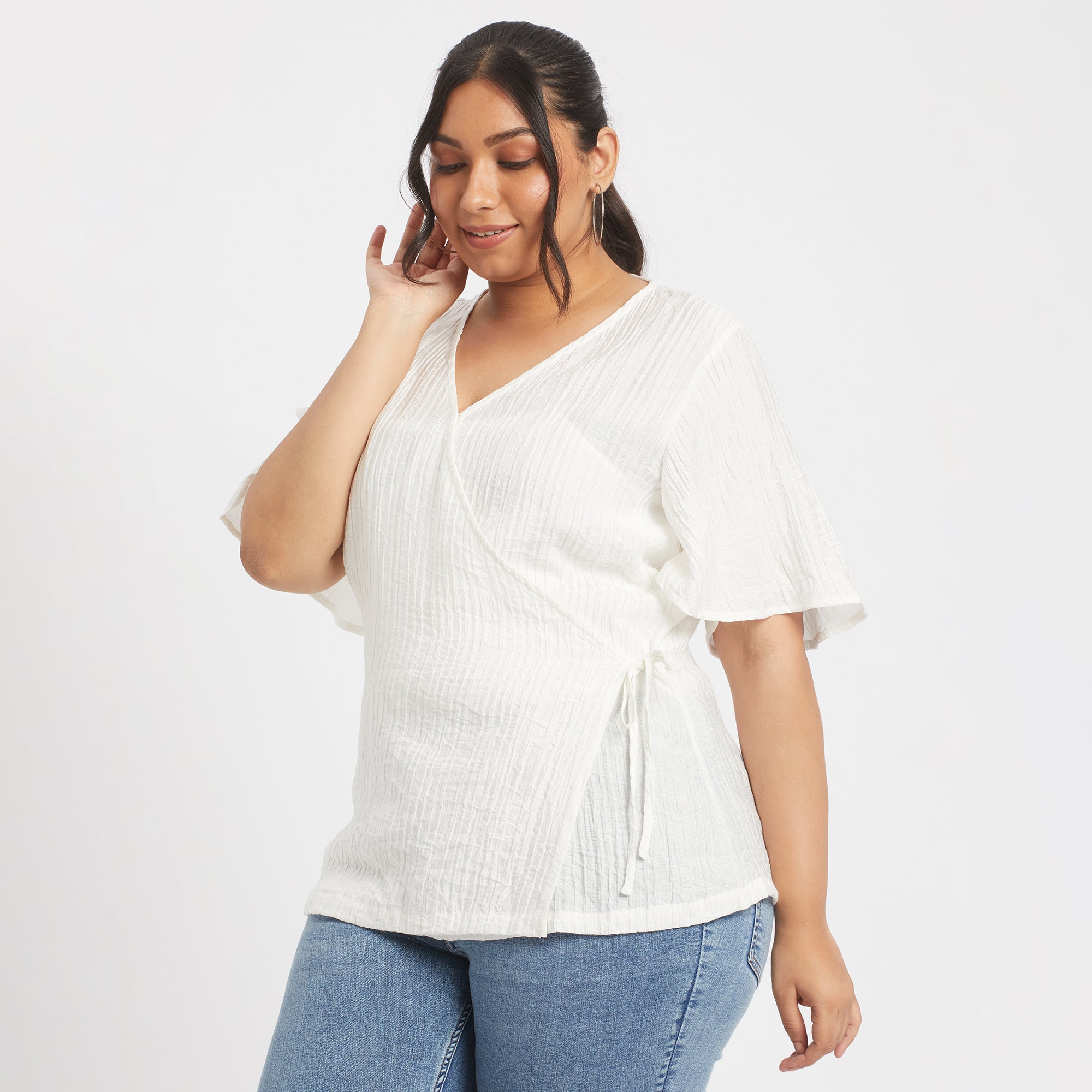 Front angled view of white viscose nylon plus size wrap top
