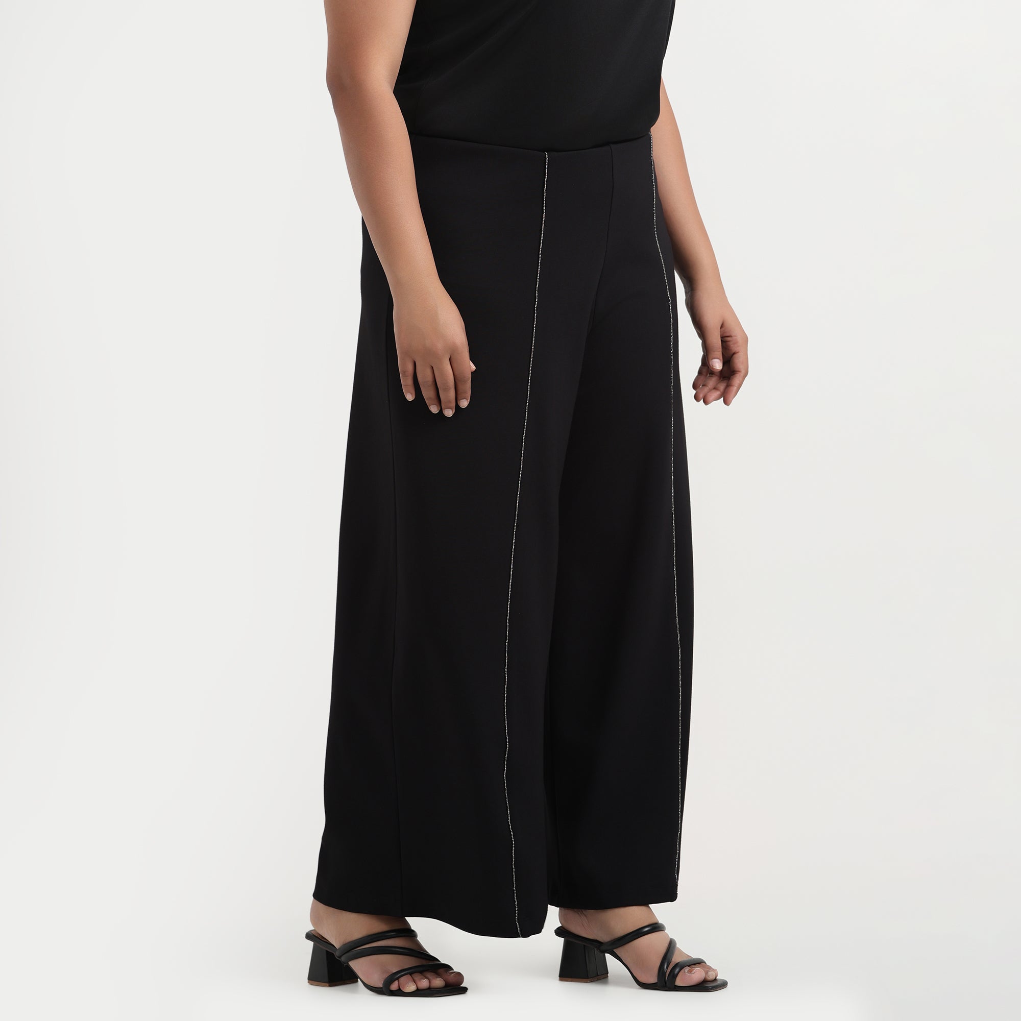 Black flared pants with rhinestone detailing, glamorous design, front view