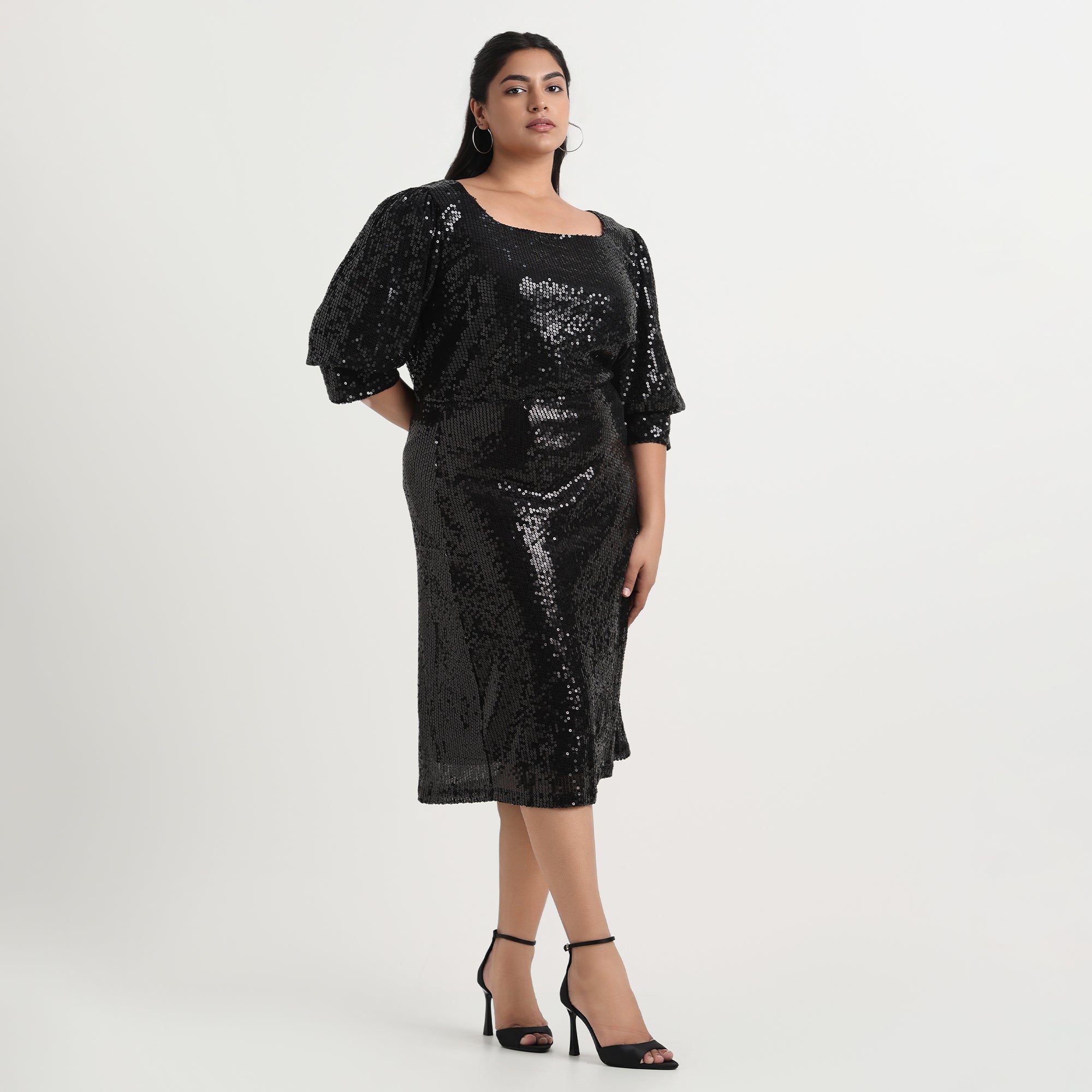 Black sequined skirt with a high-shine finish and flattering A-line cut.
