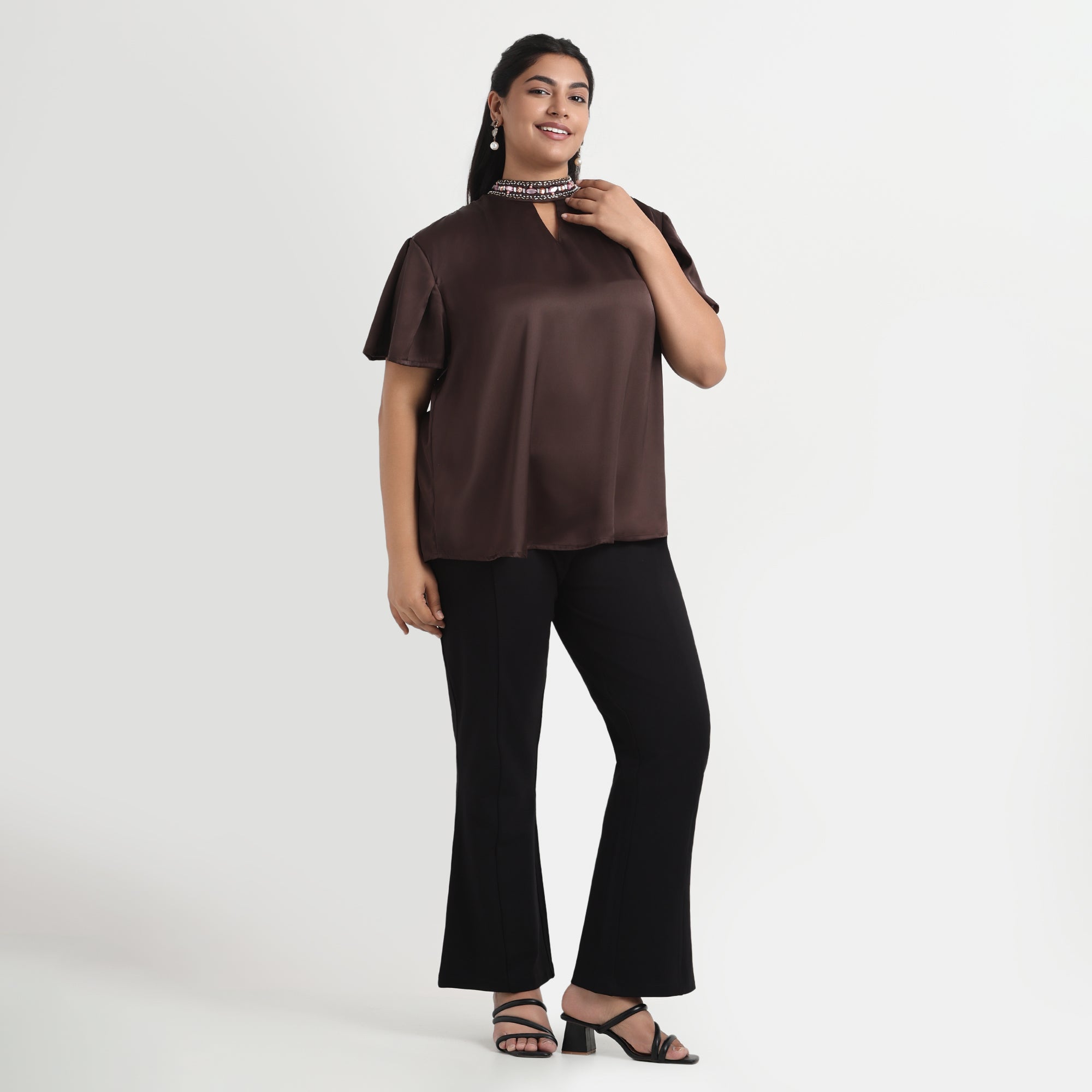 Brown velvet satin top with a smooth texture and a comfortable, relaxed fit.
