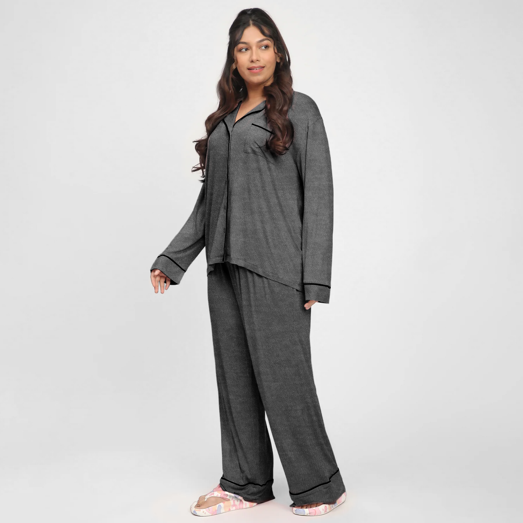 Woman wearing a gray pajama set on a white background