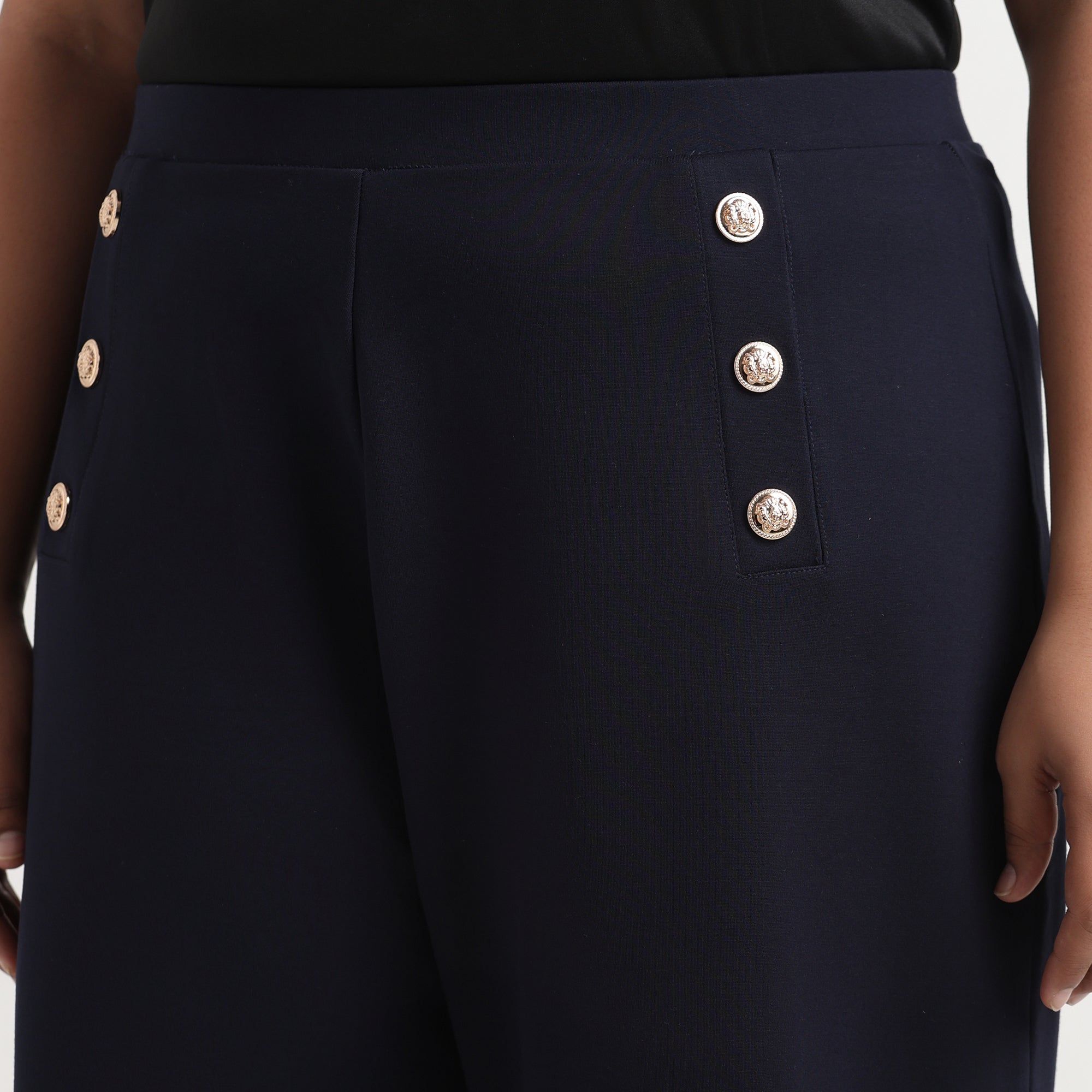 Navy blue buttoned flared pants with a high waist, tailored for a comfortable fit.

