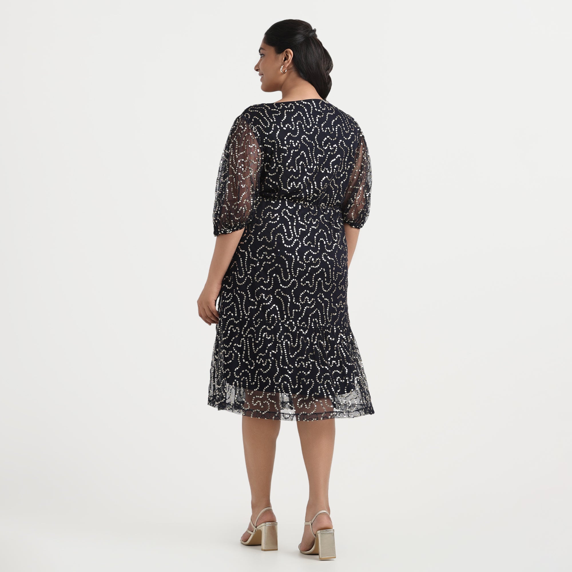 Shiny navy sequined dress with a flattering, A-line silhouette for plus sizes.
