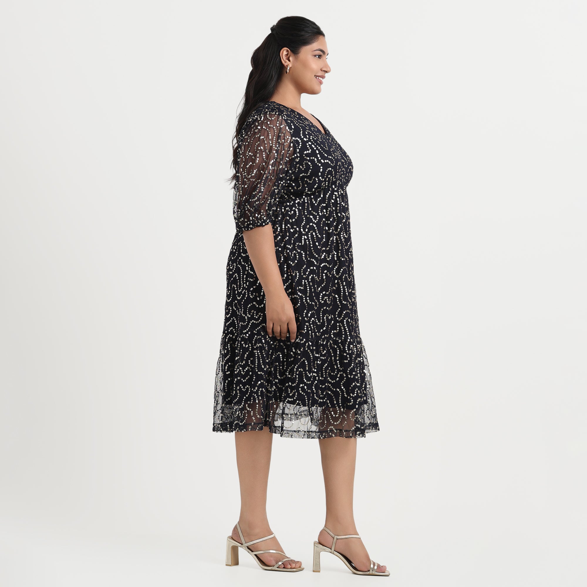 Navy sequined dress with a fitted design and an elegant, shimmering finish.
