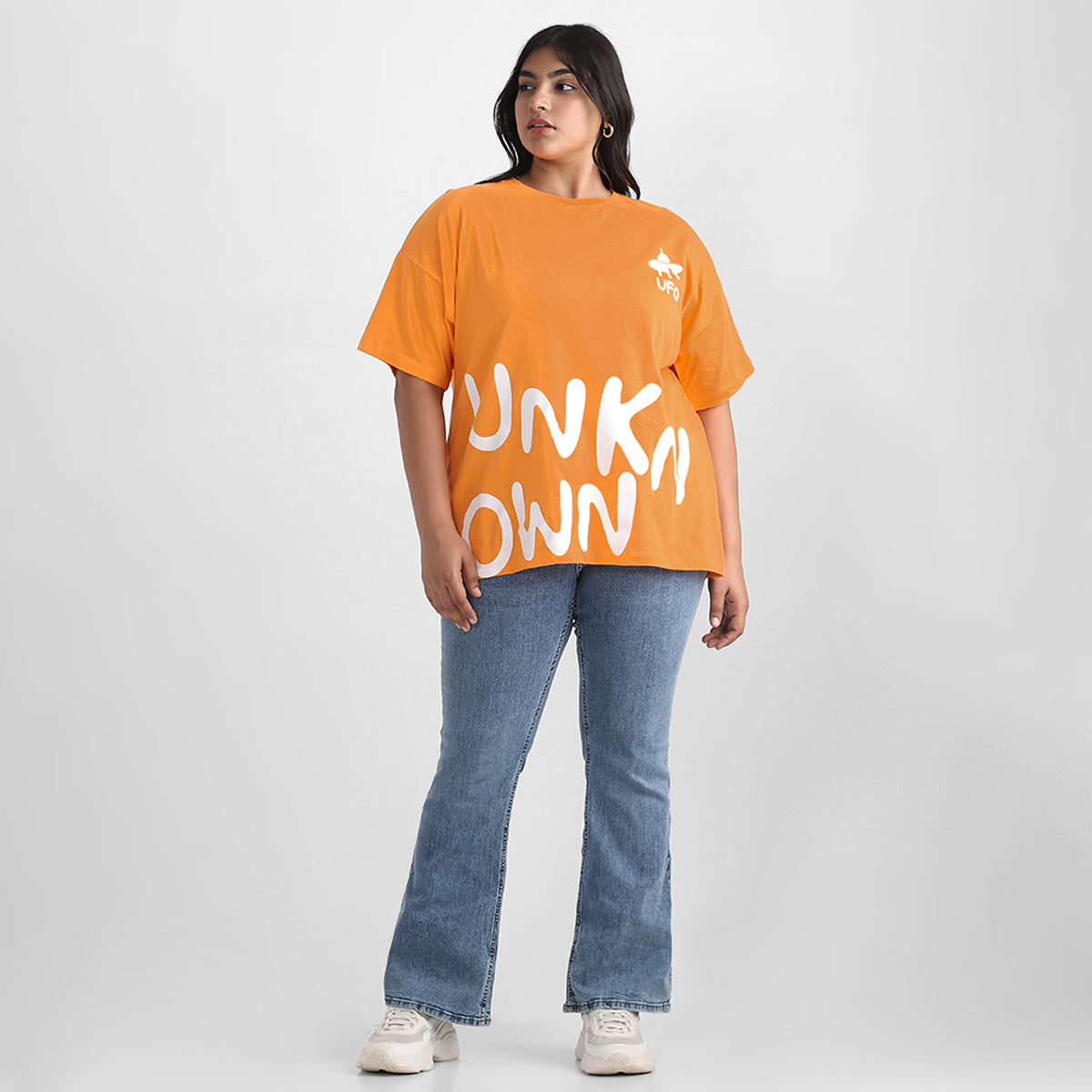 Orange tshirt with graphic print, drop shoulders, and plus-size fit.
