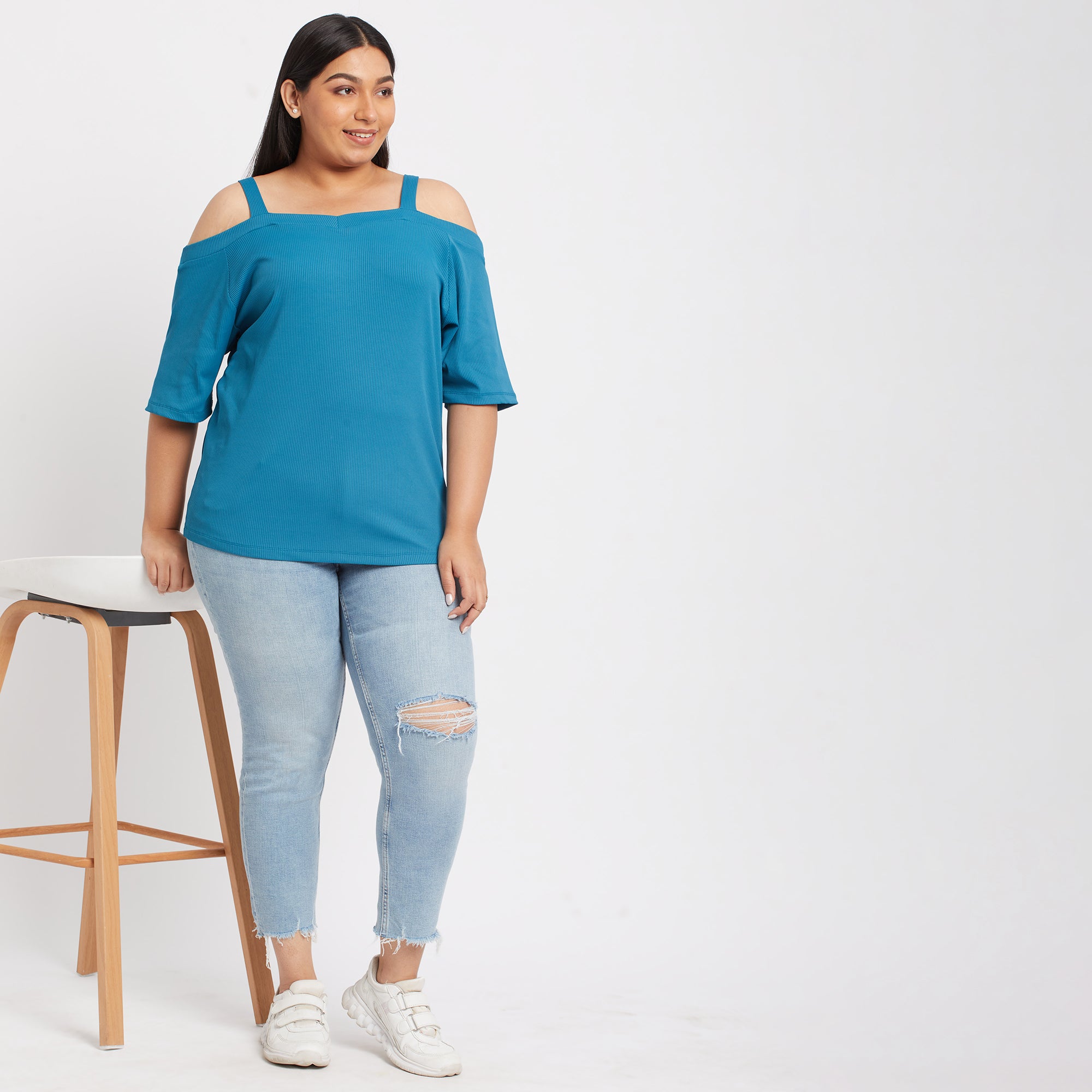 Front view of a teal off shoulder knit top with a ribbed design
