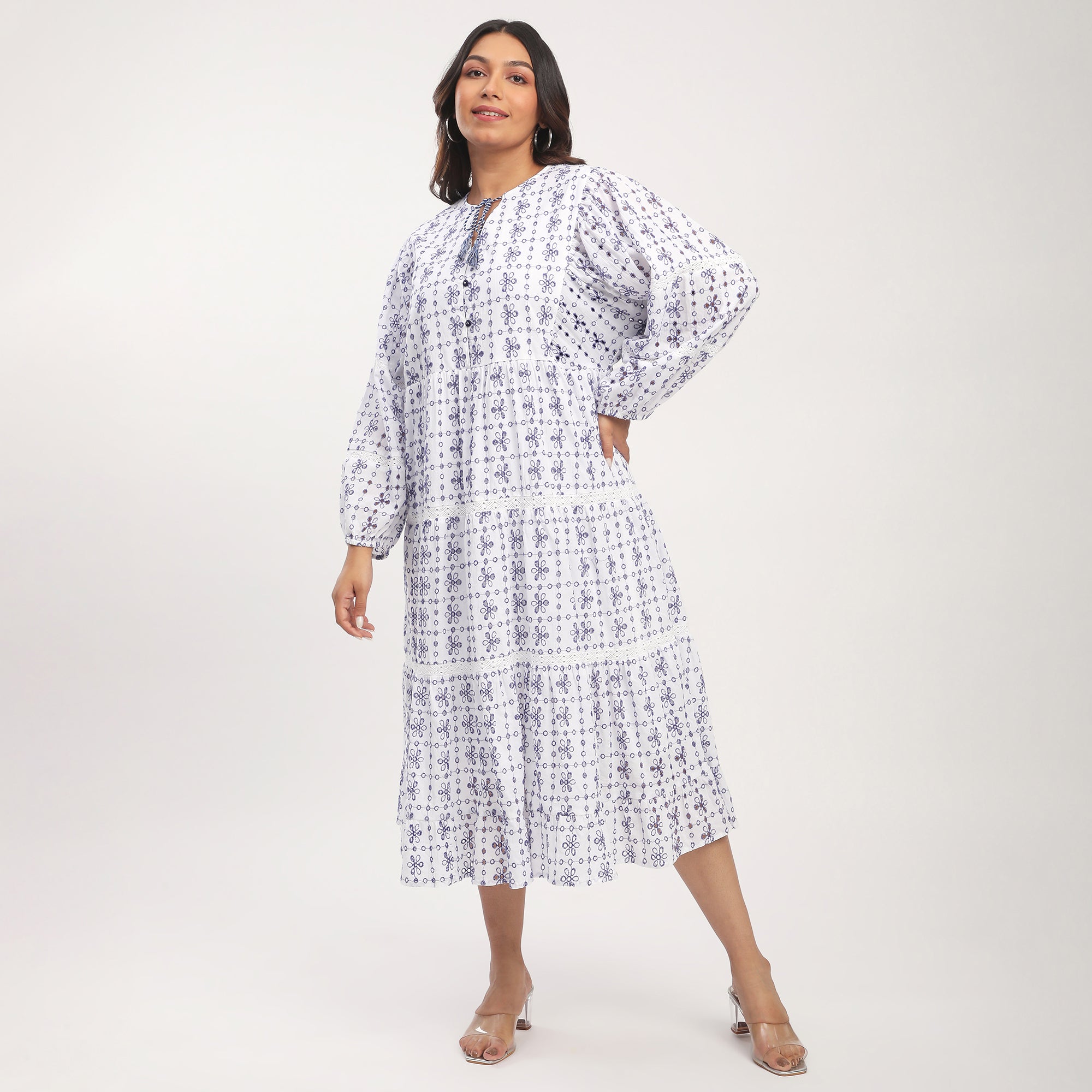 Woman wearing a blue patterned dress on a white background