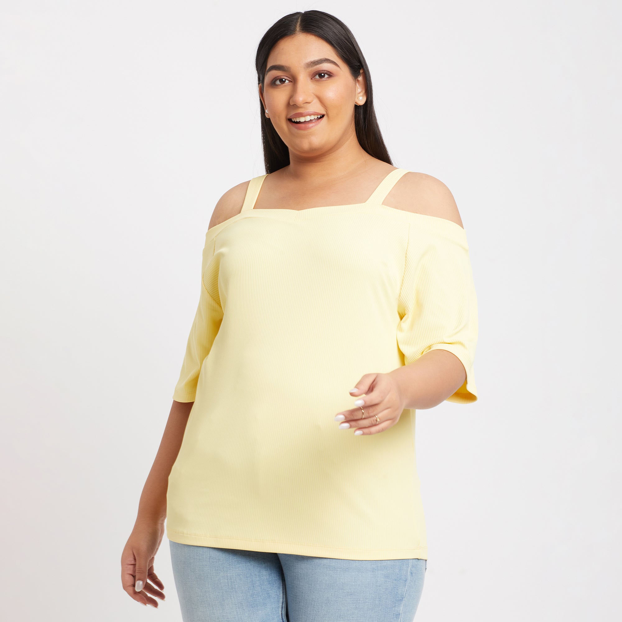 Close-up of a yellow off shoulder knit top with a ribbed design from the front