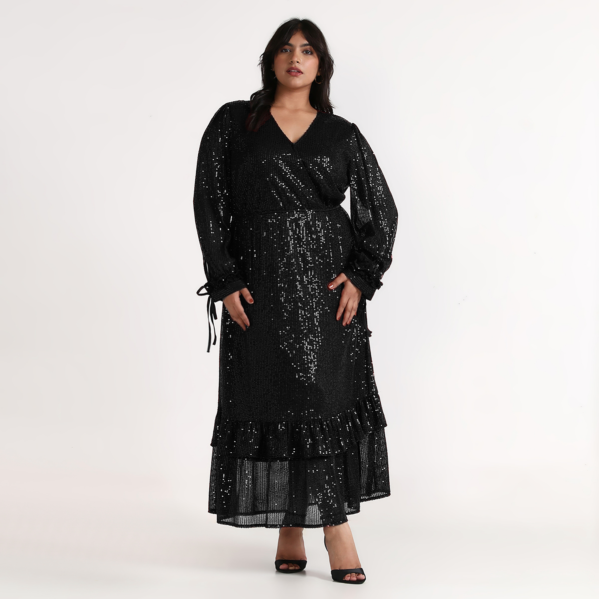 Woman wearing black sequin overlap maxi dress with full sleeves